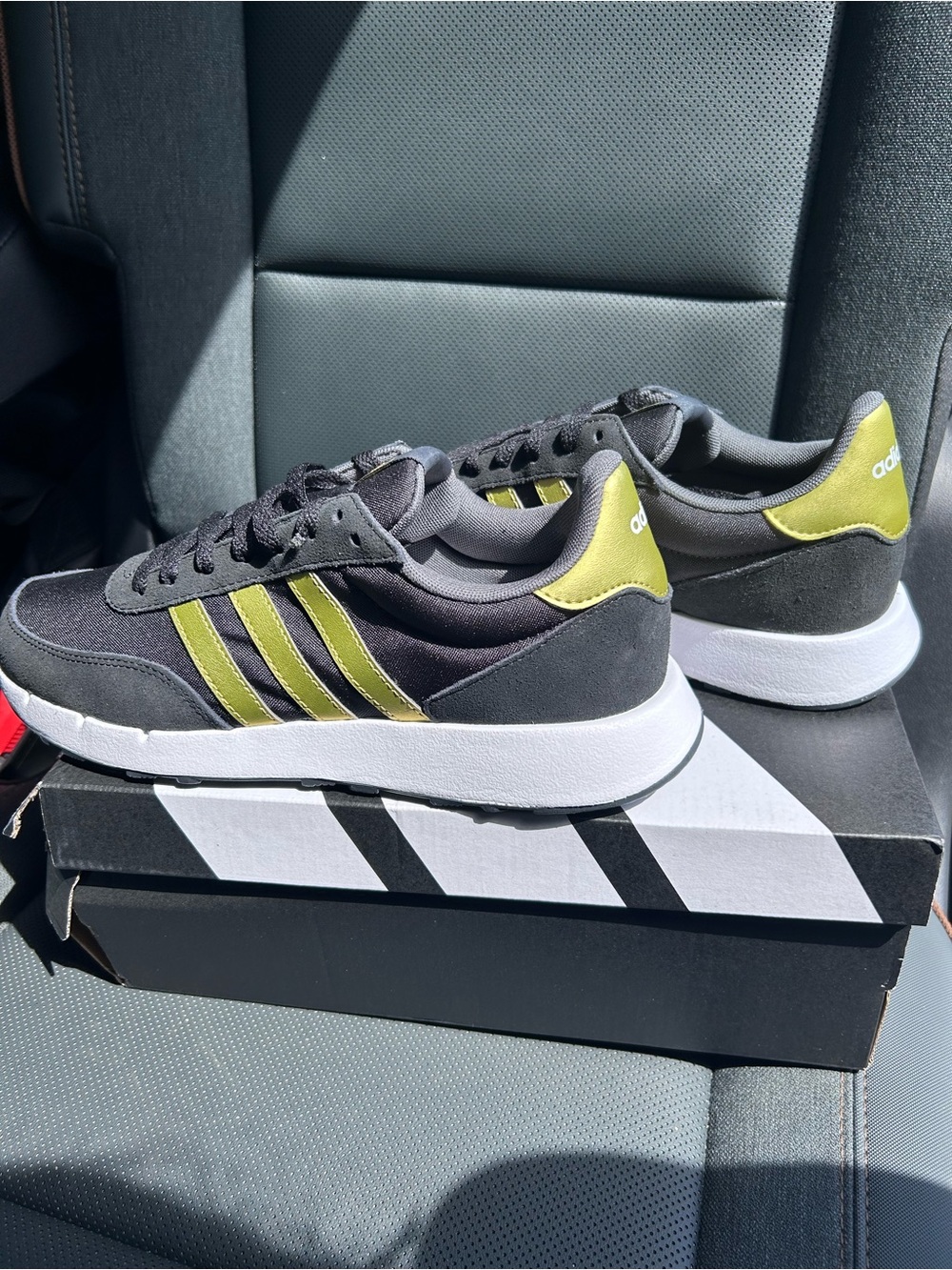 NWT Adidas women’s black sneakers with gold stripes